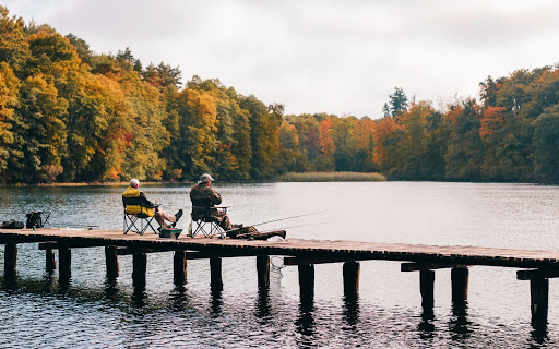 Photo of two people fishing on a lake